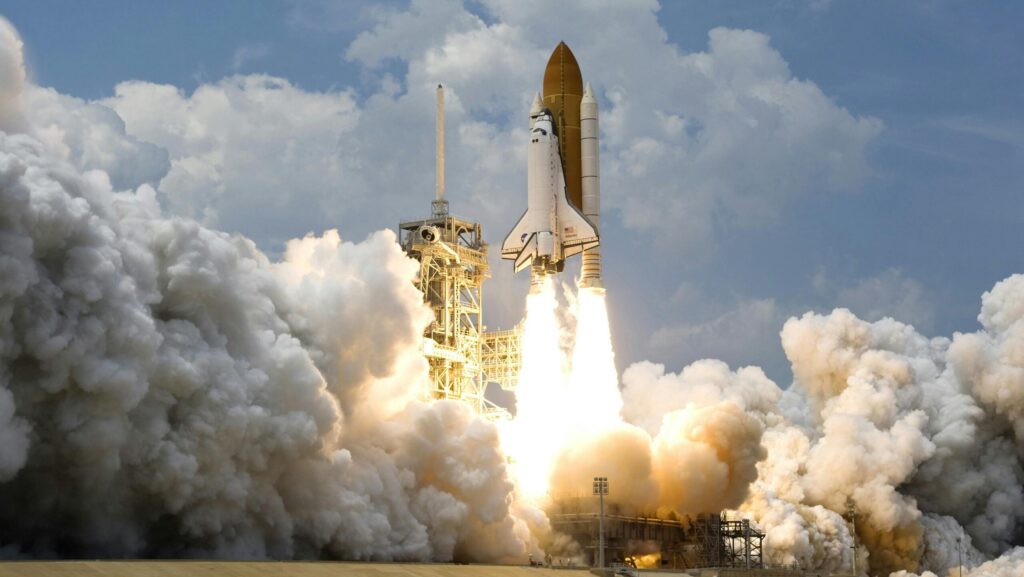 Witness the powerful launch of a space shuttle amidst massive clouds of smoke against a bright sky.